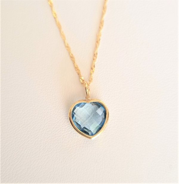 Gold heart pendant with blue topaz
